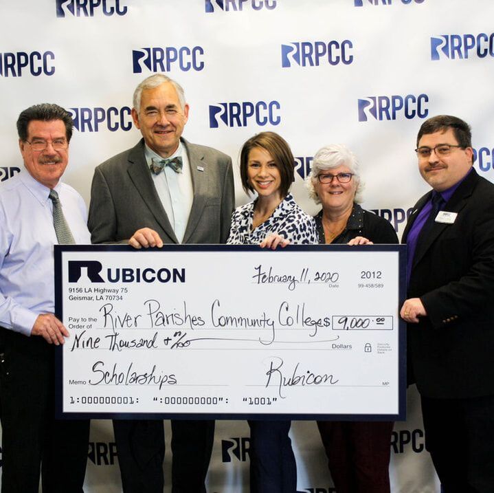 Rubicon Funds Scholarships, Community, Rubicon team members holding nine thousand dollar check written out to River Parishes Community College